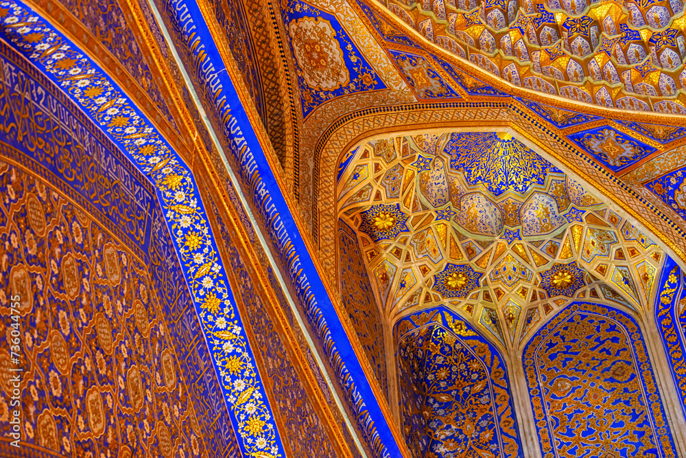 Interior of Tilya Kori Madrasah in Registan. Masterpiece of XVII century. Golden and blue. Arabic text of Qran (sacred book of muslims) used as part of ornament. Samarkand, Uzbekistan