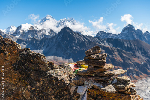 Сairn, pile of stones and snow capped Everest, Nuptse and Lhotse mountains of the Himalayas during EBC Everest Base Camp or Three Passes trekking. View from Gokyo Ri, Nepal. © Lizaveta