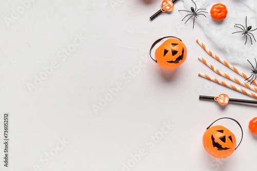 Composition with different drinking straws  pumpkins  spiders and web for Halloween celebration on light background