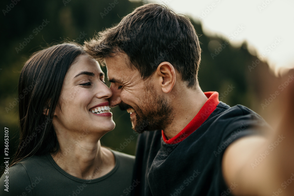 Multicultural pair shares a moment of happiness in a selfie Multicultural pair shares a moment of happiness in a selfie
