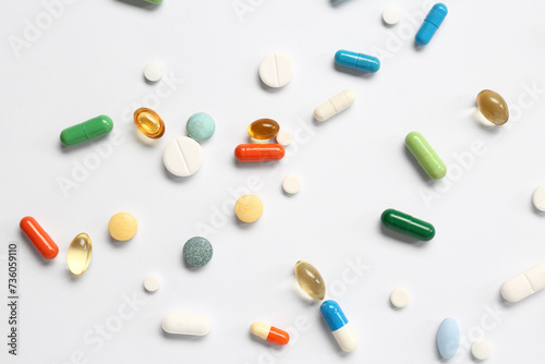 Fish oil capsules and different pills on white background