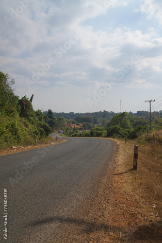 Lao Village, damaged paved road with beautiful mountain views