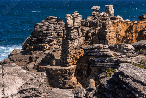 Rock formations in the site of geological interest of the cliffs of the Peniche peninsula, portugal, in a sunny day.