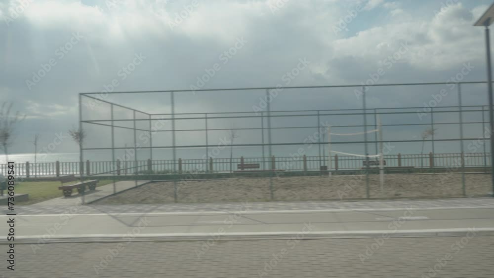 Football and basketball courts by the sea, view from a moving car. Football and basketball courts by the sea, view from a moving car.