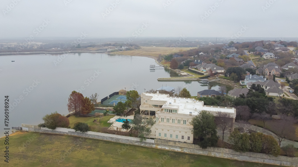 Upscale lakeside residential neighborhood with large houses, tennis court, swimming pool, private lake access fishing pier boat ramp near Arlington, Tarrant County, Dallas–Fort Worth metroplex