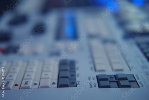 Close-up of electronic mixing console. Blurred background. Selective focus.