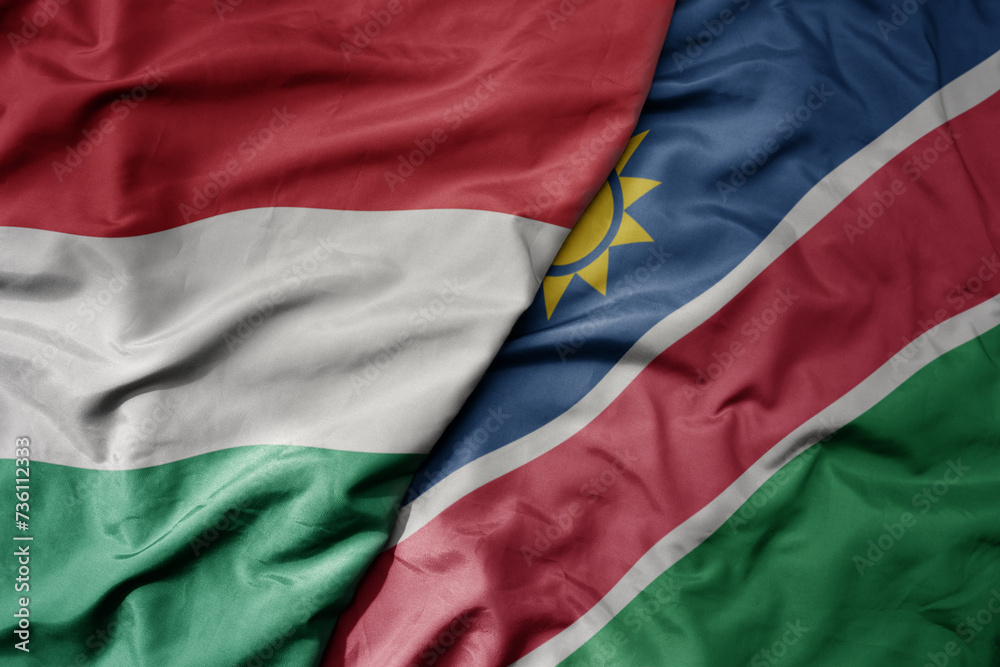 big waving national colorful flag of namibia and national flag of hungary . big waving national colorful flag of namibia and national flag of hungary .