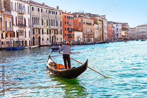 Traditional Venice gondola on Grand Canal in Venice, in a summer day, Italy.
