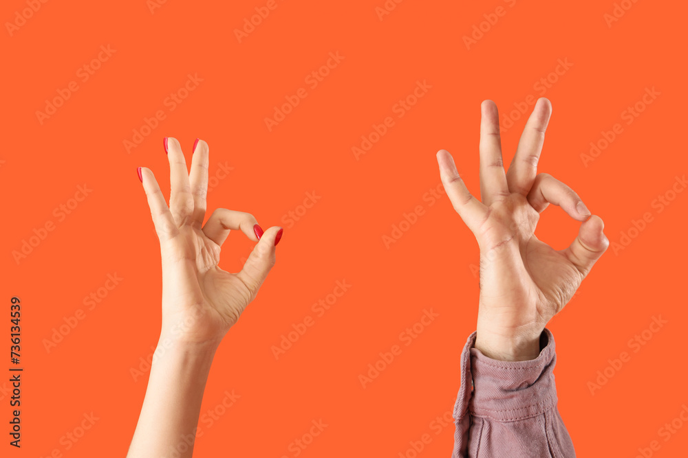 Fototapeta premium People showing OK on orange background