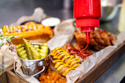 chef cooking fast food set on plate. various meat Bavarian, Frankfurt, German grilled sausages photo