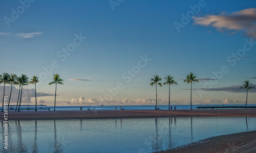 Coconut Palm Trees and Sand Fringing a Pacific Island Lagoon.
