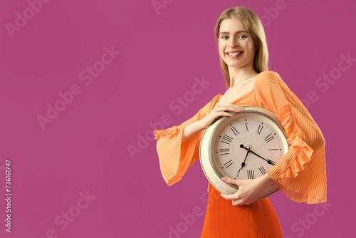 Young woman with alarm cloc...