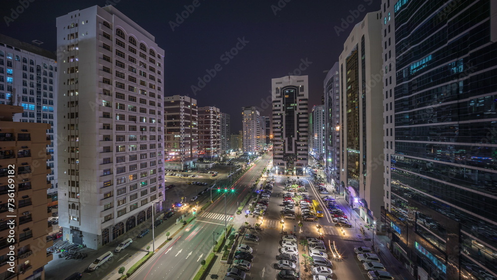 Residential buildings and modern city architecture of Abu Dhabi aerial timelapse during all night, UAE.