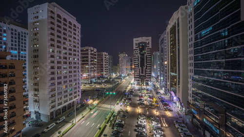 Residential buildings and modern city architecture of Abu Dhabi aerial timelapse during all night  UAE.