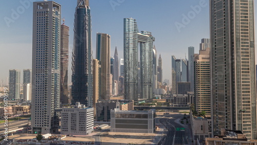 Many towers and skyscrapers with traffic on streets in Dubai Downtown and financial district morning timelapse. © neiezhmakov