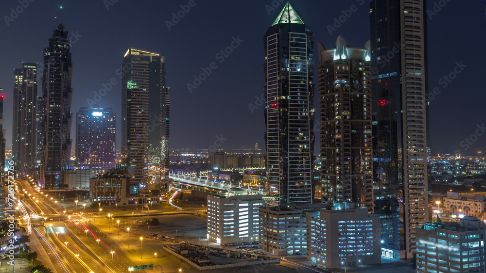 Fototapeta premium Business bay district skyline with modern architecture all night timelapse from above.