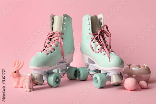 Vintage roller skates with Easter eggs and toys bunny on pink background