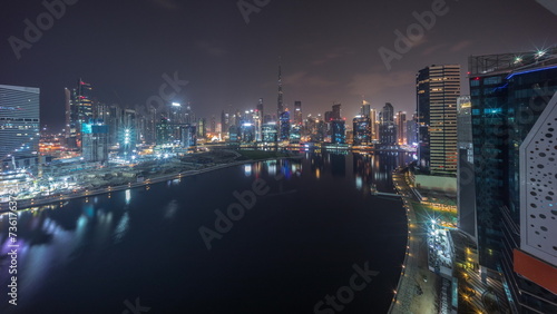 Aerial view to Dubai Business Bay and Downtown with the various skyscrapers and towers all night timelapse