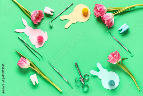 Frame made of dental tools with plastic teeth, Easter rabbits and tulips on green background