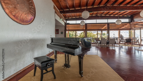 Panorama showing Interior of a modern hotel cafe bar restaurant with piano and fireplace timelapse