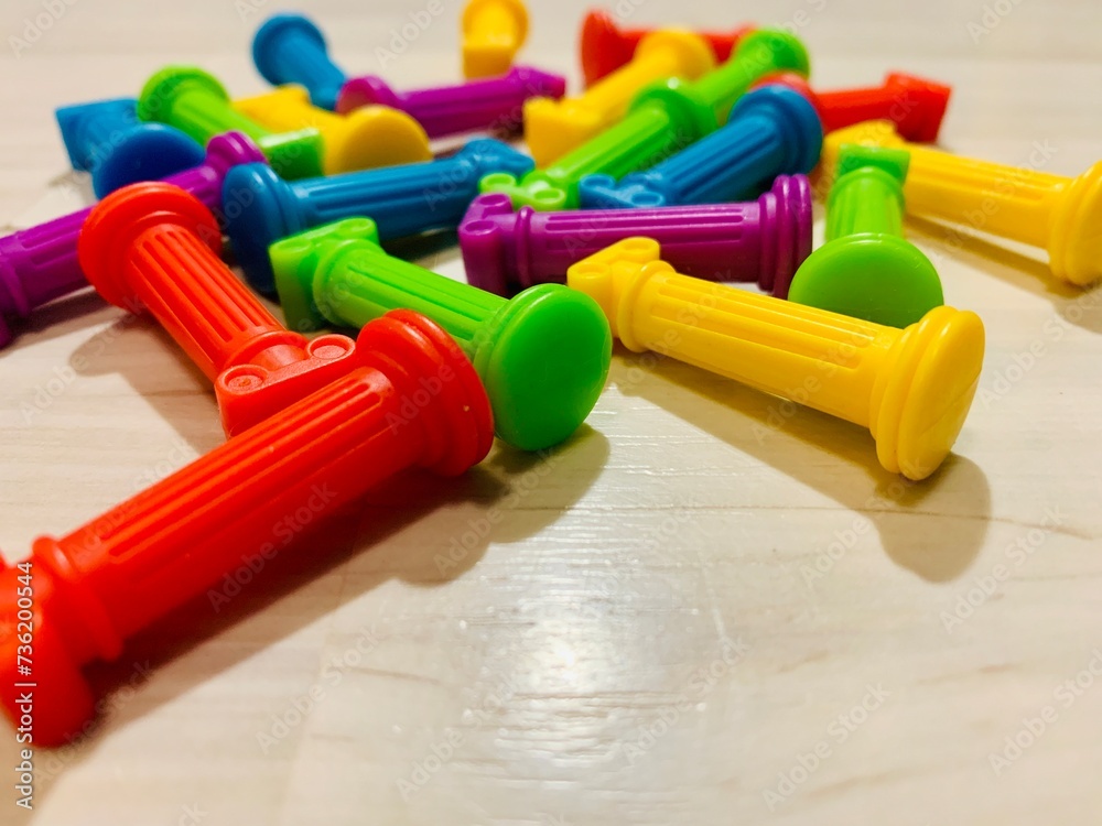 small columns, parts of educational construction sets for children are scattered on floor colored green red blue yellow purple yellow puzzle pieces Children play with sets. Child development small columns, parts of educational construction sets for children are scattered on floor colored green red blue yellow purple yellow puzzle pieces Children play with sets. Child development