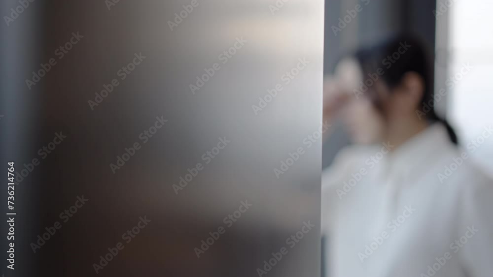 Young asian business woman upset worried, looking out of window, thinking of problems. Depressed lady feeling doubtful about hard decision, mental stress concept, disappointed, saddened Young asian business woman upset worried, looking out of window, thinking of problems. Depressed lady feeling doubtful about hard decision, mental stress concept, disappointed, saddened