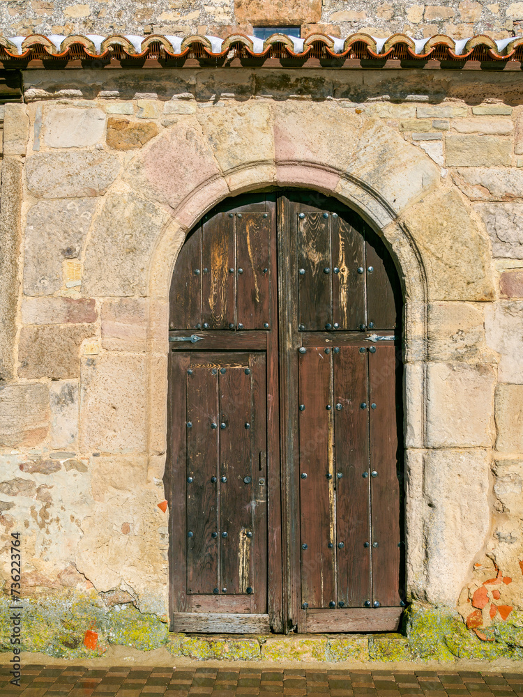Wooden aged antique door of an European rural village.