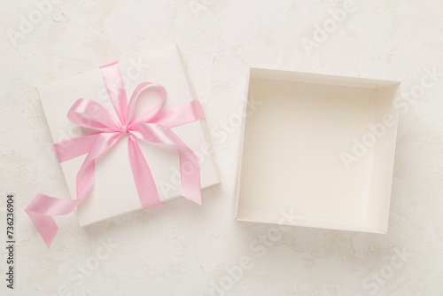 White open gift box on concrete background, top view