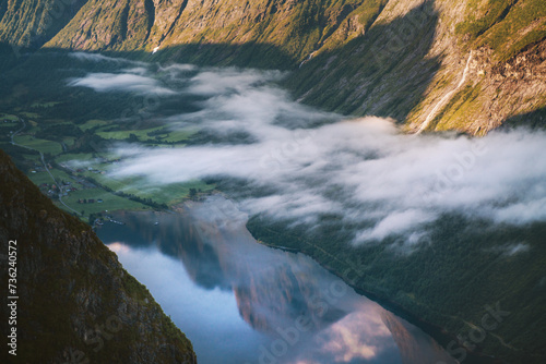 Aerial fjord view in Norway mountain reflection in water landscape morning clouds, Sunnmore Alps scandinavian nature beautiful destinations travel scenery