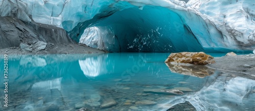 Majestic ice cave with a massive rock formation in the center surrounded by icy walls © 2rogan