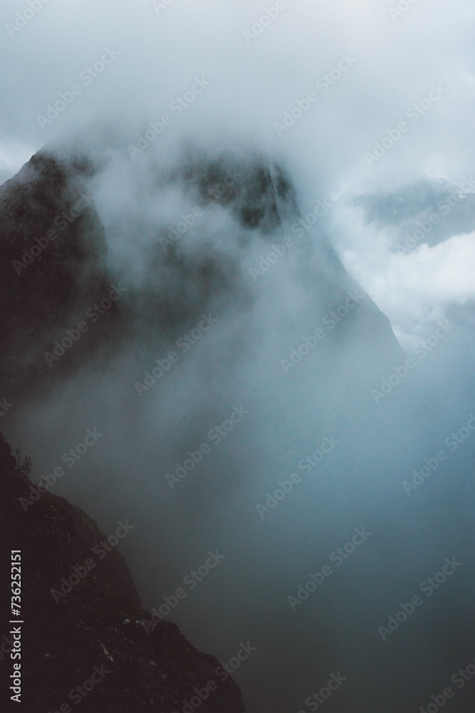Foggy misty mountains landscape in Norway scandinavian nature moody minimalistic scenery travel destination dramatic view