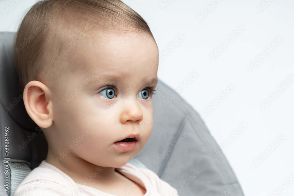 Thoughtful Baby in Highchair: Innocence and Depth. Concept of Childhood Contemplation