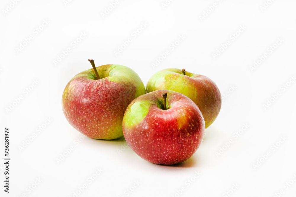 Three red-green ripe apples on a white isolated background Three red-green ripe apples on a white isolated background