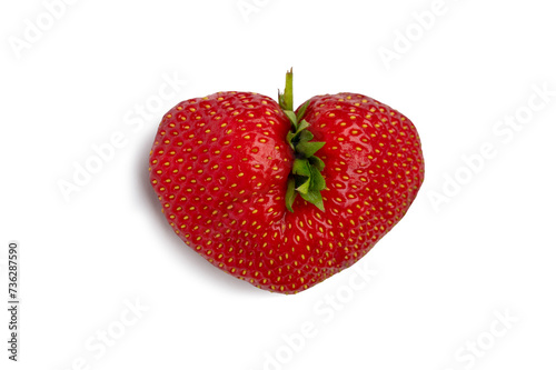 Ugly strawberry in the shape of a heart. Funny, ugly vegetables.