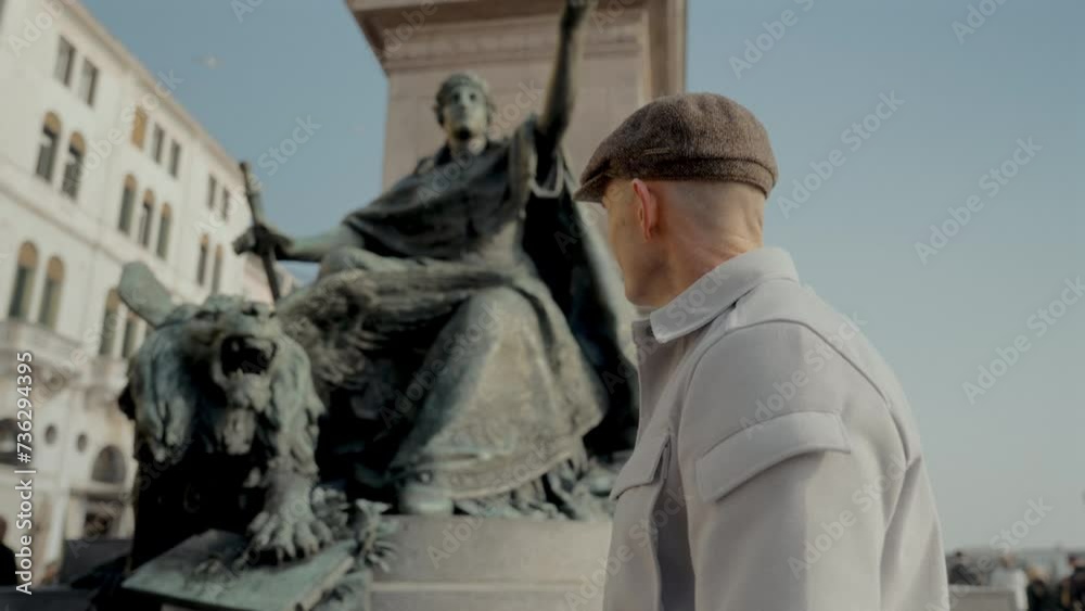 Man Observes The Historic Saint Mark s Lion Statue In Venice Man Observes The Historic Saint Mark s Lion Statue In Venice