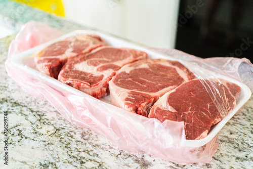 Unpacking Rib Eye Steak in Modern Kitchen photo