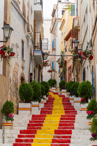 Fototapeta Naklejka Na Ścianę i Meble -  Stairs in the old quarter of Calpe painted with red and yellow colors