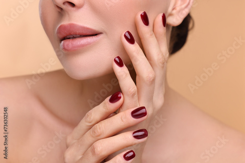 Woman with beautiful lips on beige background  closeup