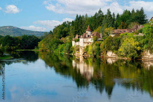 River Dordogne in Meyronne, Lot, France with a chateau reflected in the river © heather