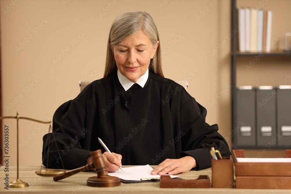 Judge working with document at table indoors Judge working with document at table indoors