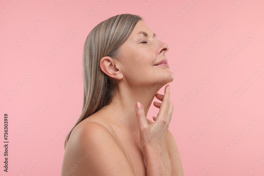 Beautiful woman with healthy skin on pink background