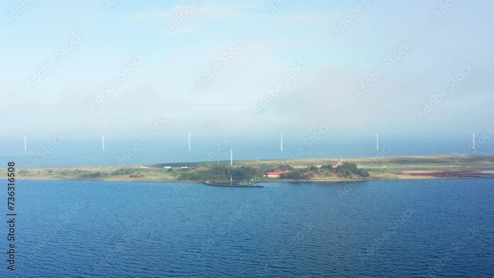 Aerial Panorama Of An Island Against Wind Turbines On The Sea Aerial Panorama Of An Island Against Wind Turbines On The Sea