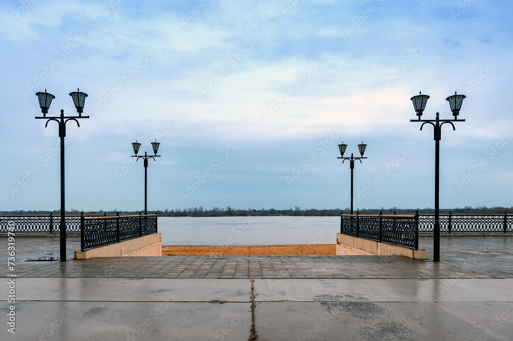 Embankment of Murom. View of the Oka River. Lampposts and sand.