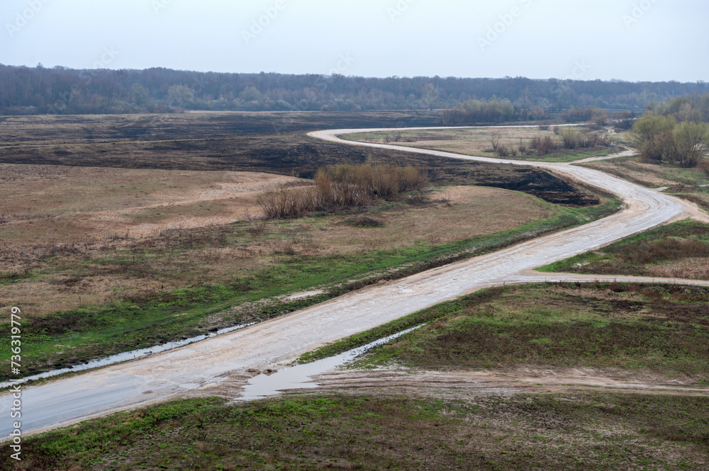 Spring landscape. The road leaves into the distance, along empty fields. Spring landscape. The road leaves into the distance, along empty fields.