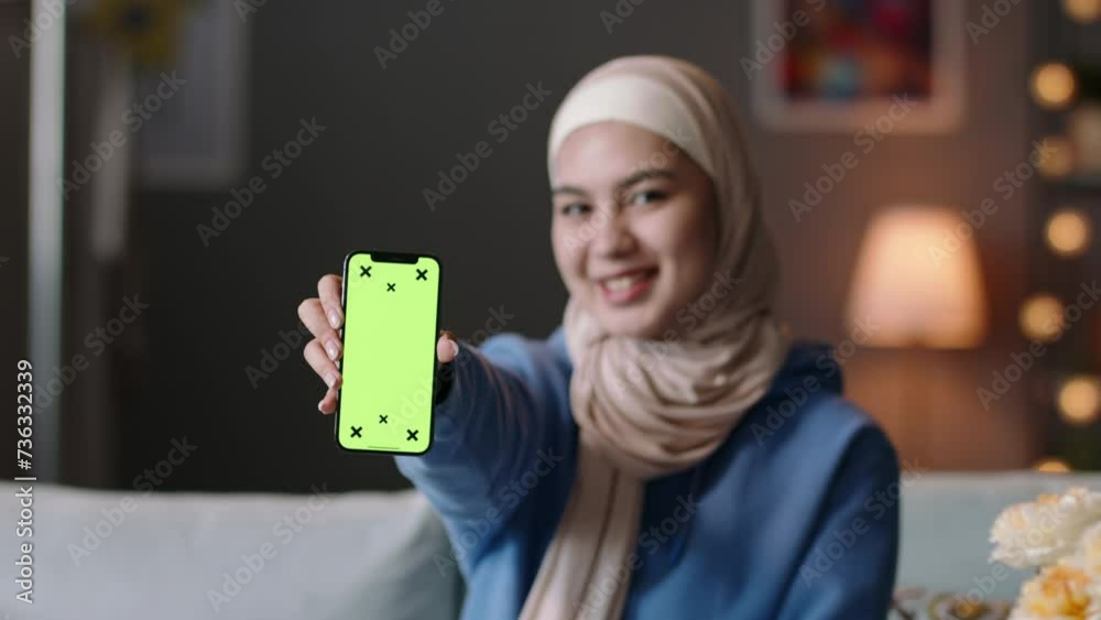 Woman shows phone with green screen. Young female teenage muslim woman ...