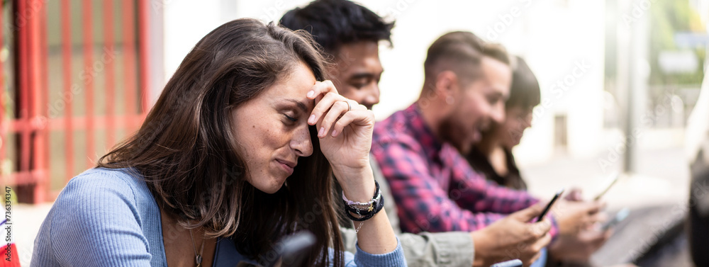 Obraz premium Horizontal banner or header with pensive friends group using smartphone sitting at university college backyard - Young people addicted by mobile smart phone