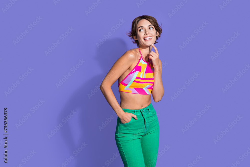 Photo of lovely pretty woman wear stylish clothes hand touch face look interesting offer empty space isolated on purple color background Photo of lovely pretty woman wear stylish clothes hand touch face look interesting offer empty space isolated on purple color background