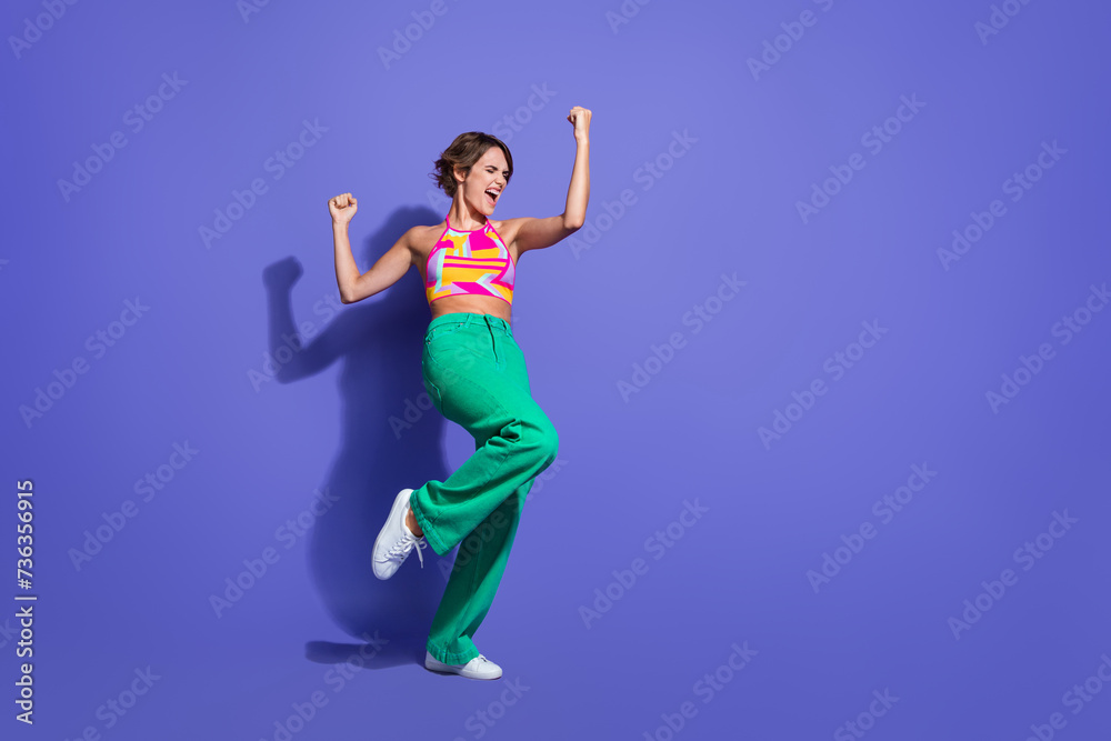 Full length photo of crazy cheerful glad woman win lottery jackpot scream yes hooray empty space isolated on purple color background
