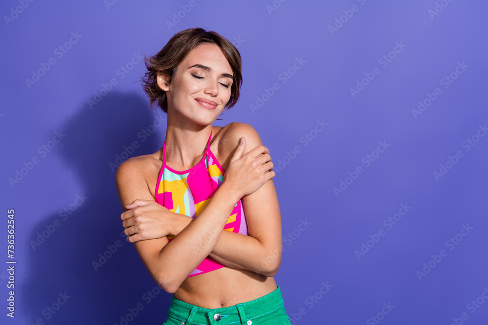 Photo of cute dreamy sweet gentle woman wear trendy striped clothes hug herself empty space isolated on purple color background Photo of cute dreamy sweet gentle woman wear trendy striped clothes hug herself empty space isolated on purple color background