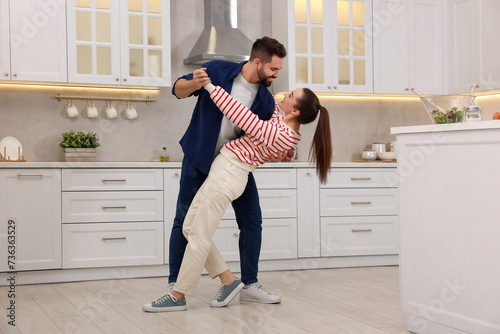 Happy lovely couple dancing together in kitchen © New Africa